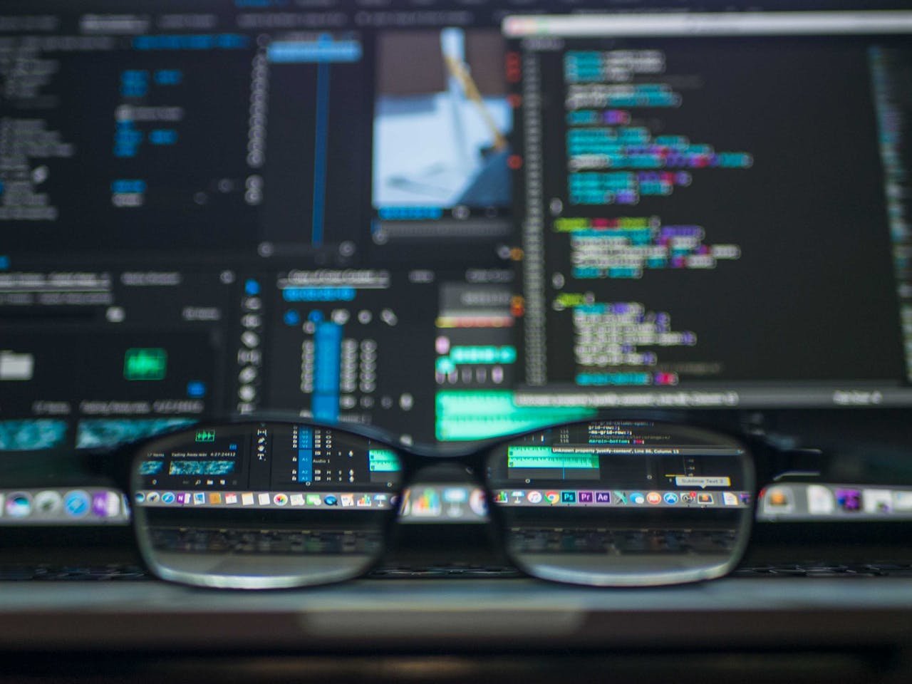 about-04 Eyeglasses reflecting computer code on a monitor, ideal for technology and programming themes.